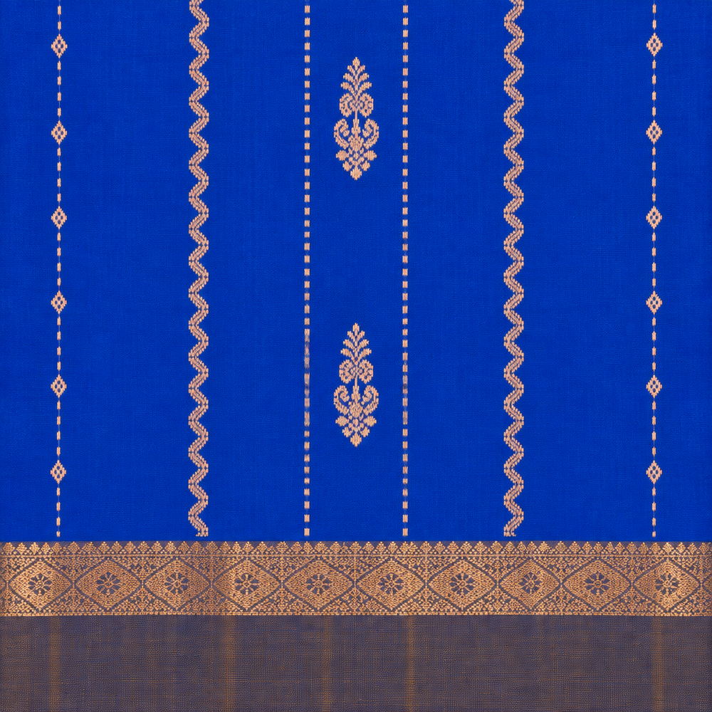Close-up of blue pure silk saree body with gold floral motifs and wave-like zari details
