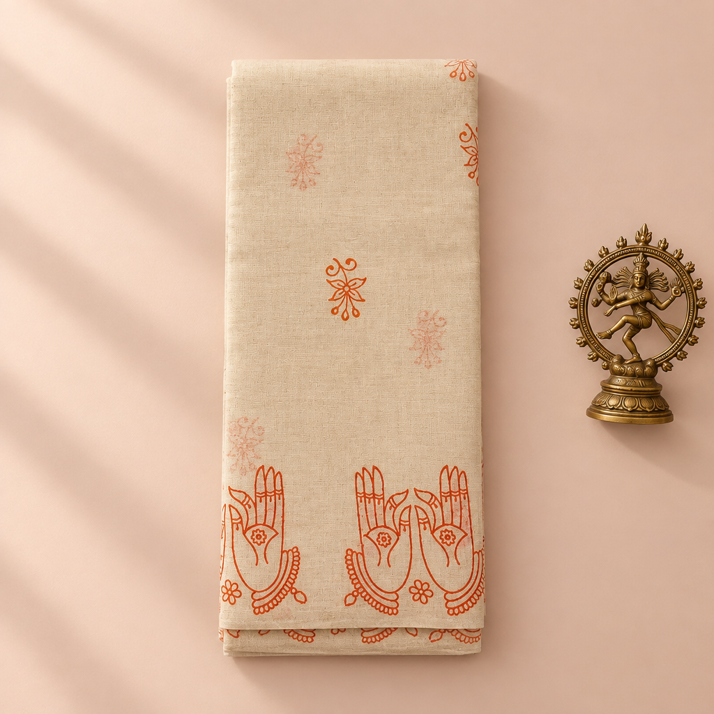 Cream cotton dance saree with orange mudra print, folded flat lay with Nataraja prop