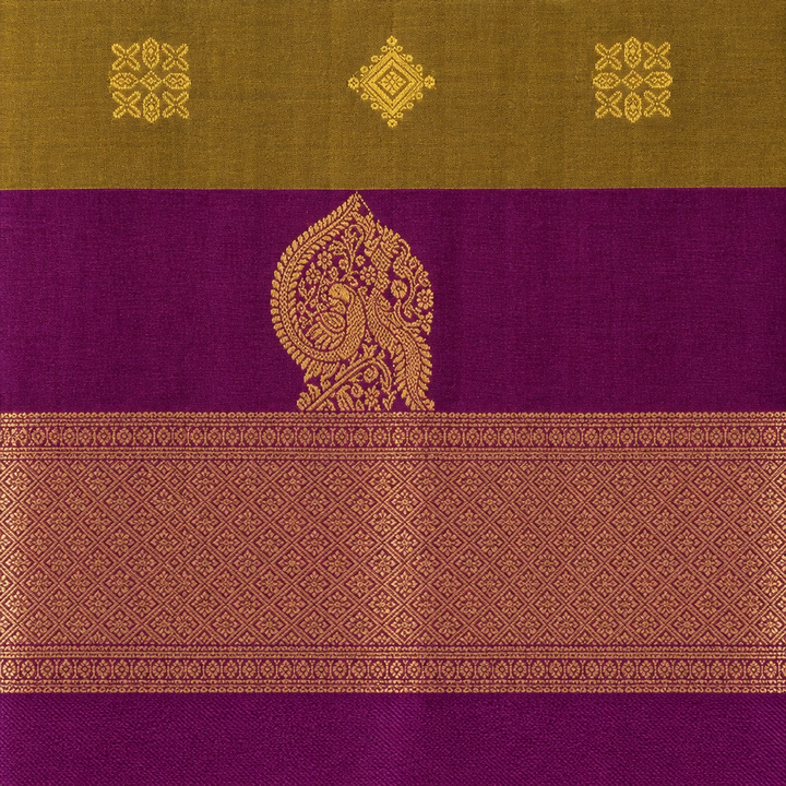 Close-up of olive green and purple semi-silk saree with ornate gold motif and diamond-pattern zari border
