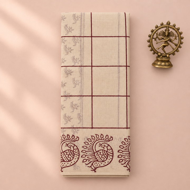 Cream checked cotton dance saree with peacock print border, folded flat lay with Nataraja prop