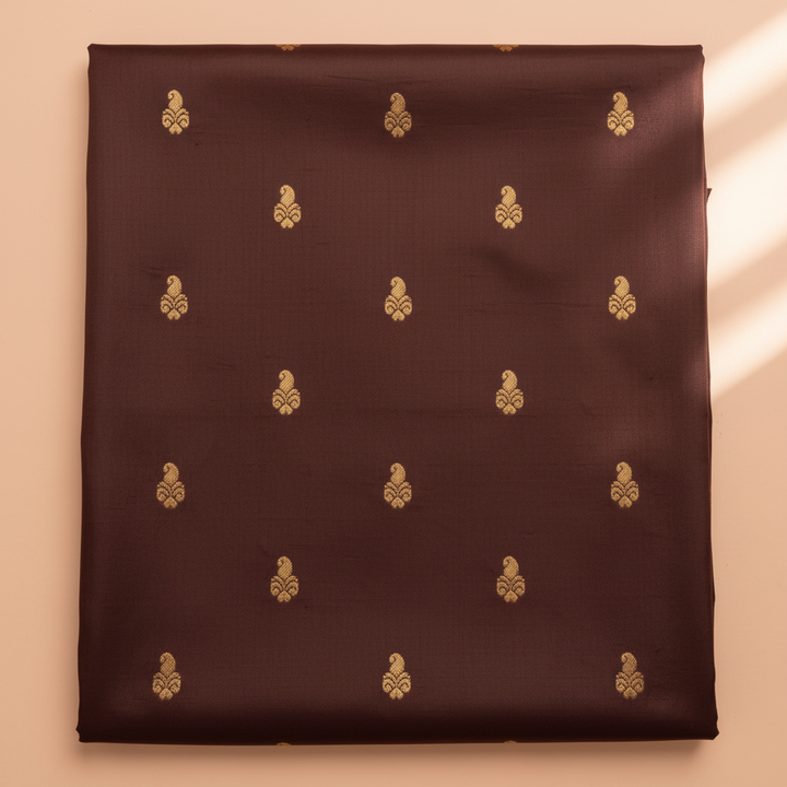 Dark brown pure silk saree body with gold zari motifs close-up