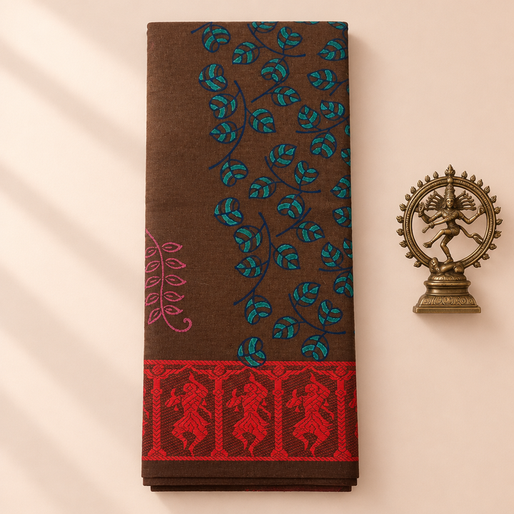 Brown cotton dance saree with teal leaf print and red border, folded flat lay with Nataraja prop