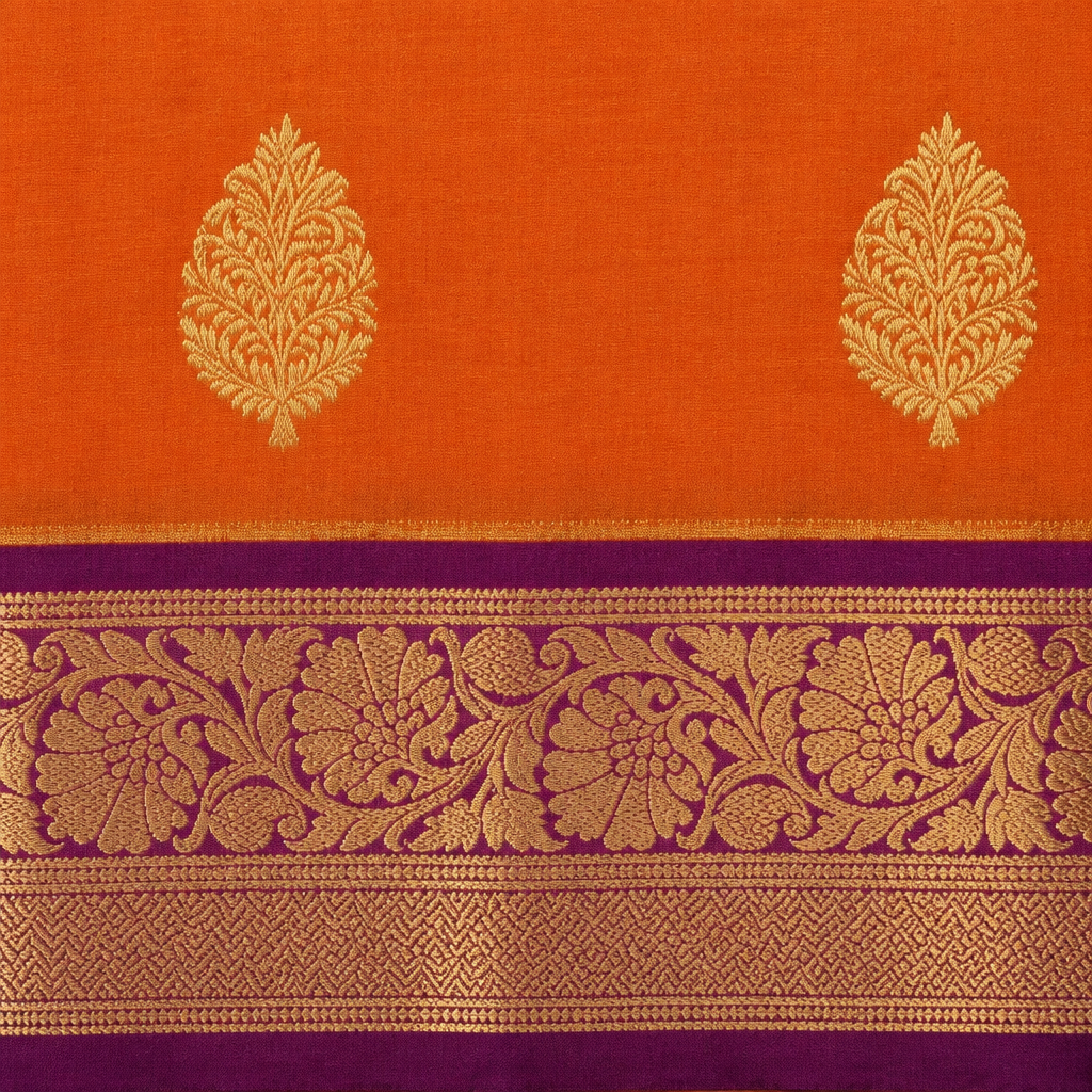 Close-up of orange and purple semi-silk saree with gold floral zari border