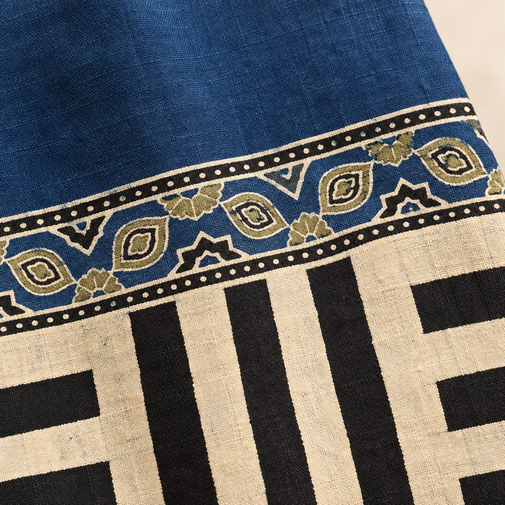 Close-up of blue Ajrakh saree border and black cream striped panel