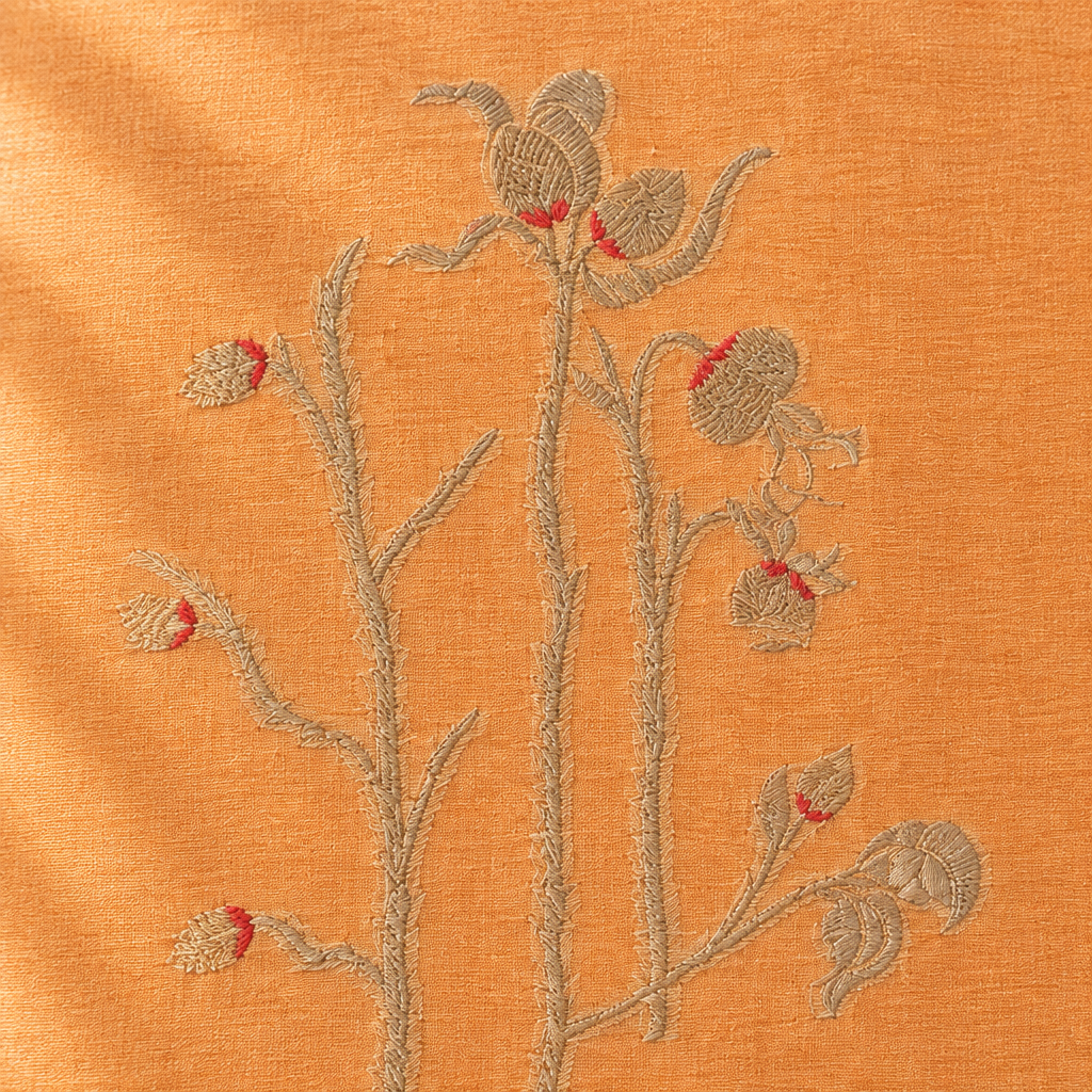 Close-up of the peach-orange pure Tussar silk saree body with silver floral vine motif