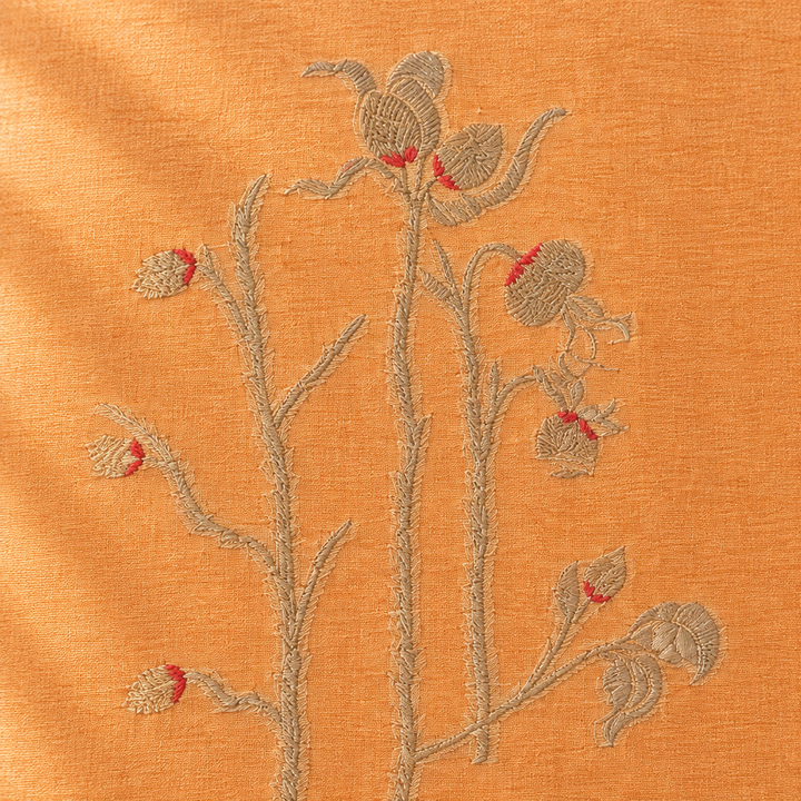 Close-up of the peach-orange pure Tussar silk saree body with silver floral vine motif