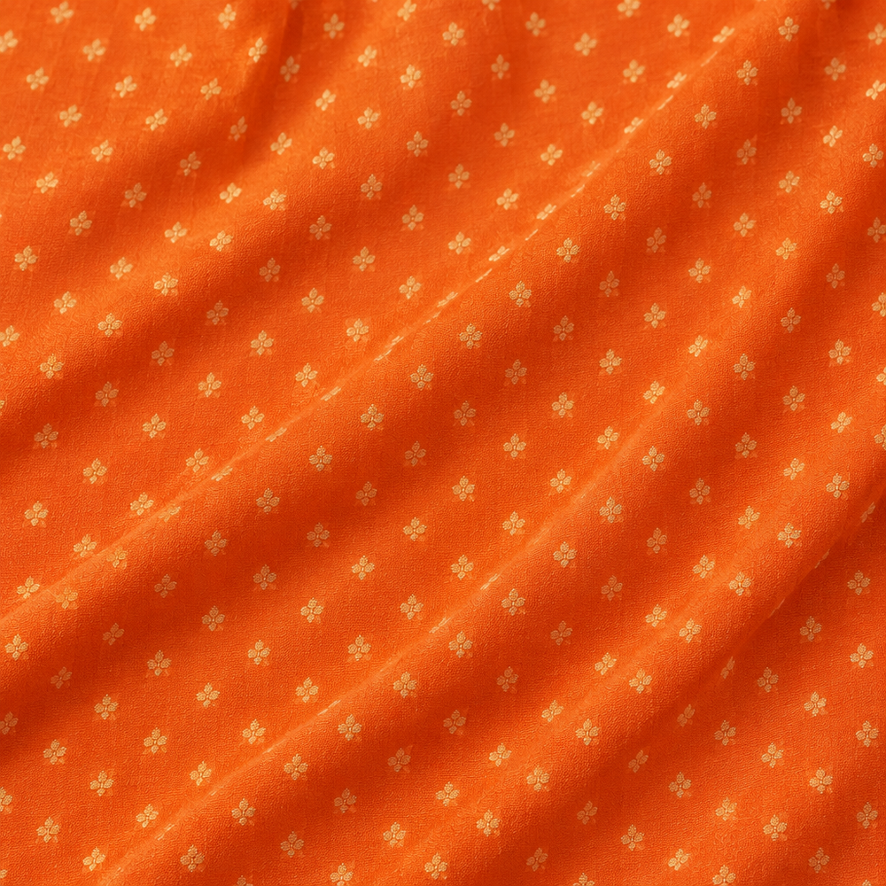 Close-up of the orange Banaras georgette saree body with fine gold dotted butti motifs