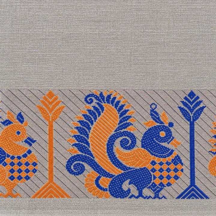Close-up of blue and orange peacock motif on grey saree border