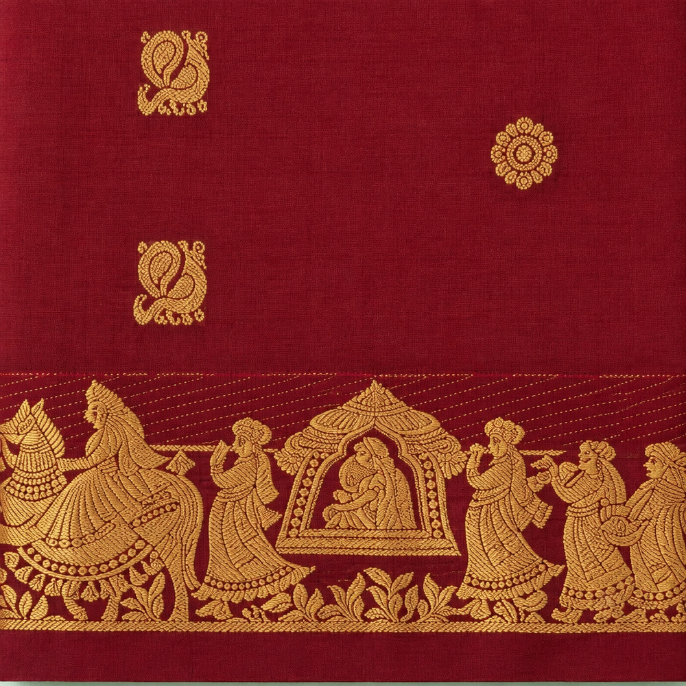 Close-up of maroon pure silk saree with figurative gold zari border and temple-inspired centre