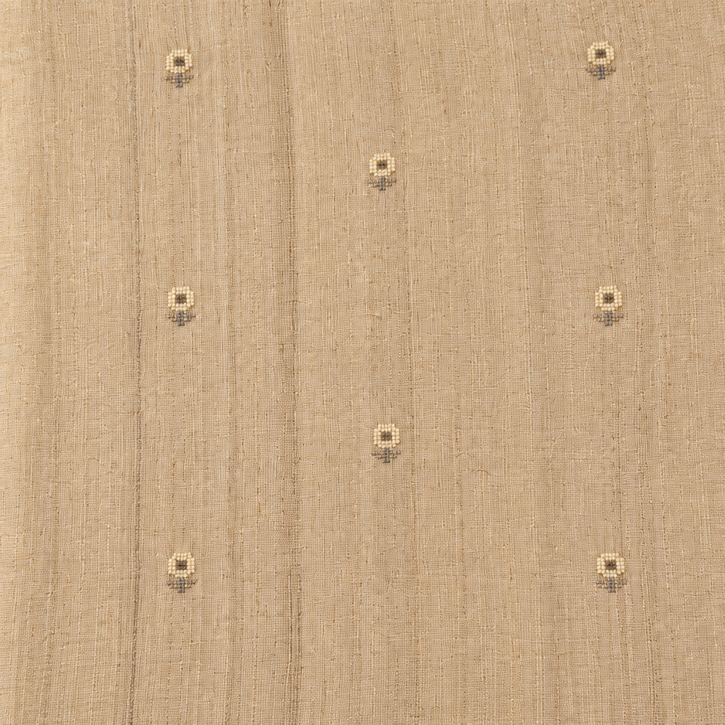 Close-up of the beige pure Tussar silk saree body showing woven texture and scattered butti motifs