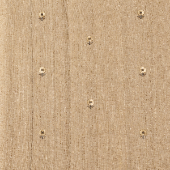 Close-up of the beige pure Tussar silk saree body showing woven texture and scattered butti motifs
