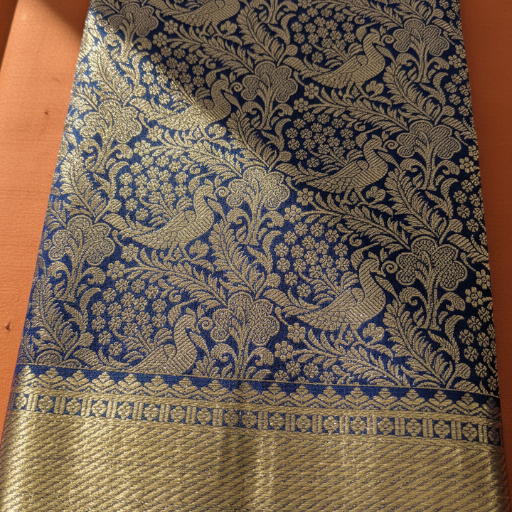 Navy blue Kanchipuram silk saree body with peacock and floral zari jaal close-up