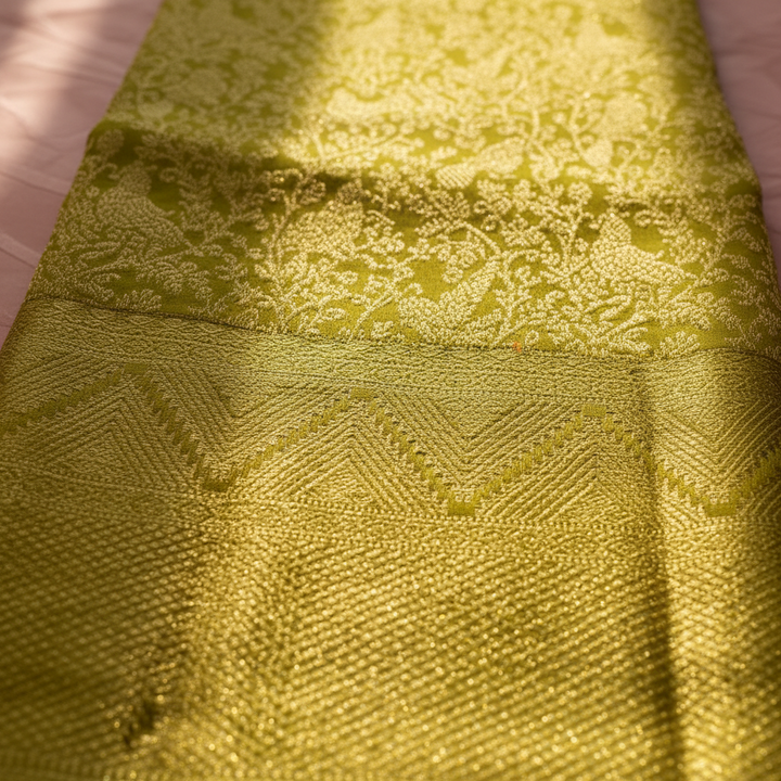 Olive green Kanchipuram silk saree border and chevron tissue pallu detail close-up