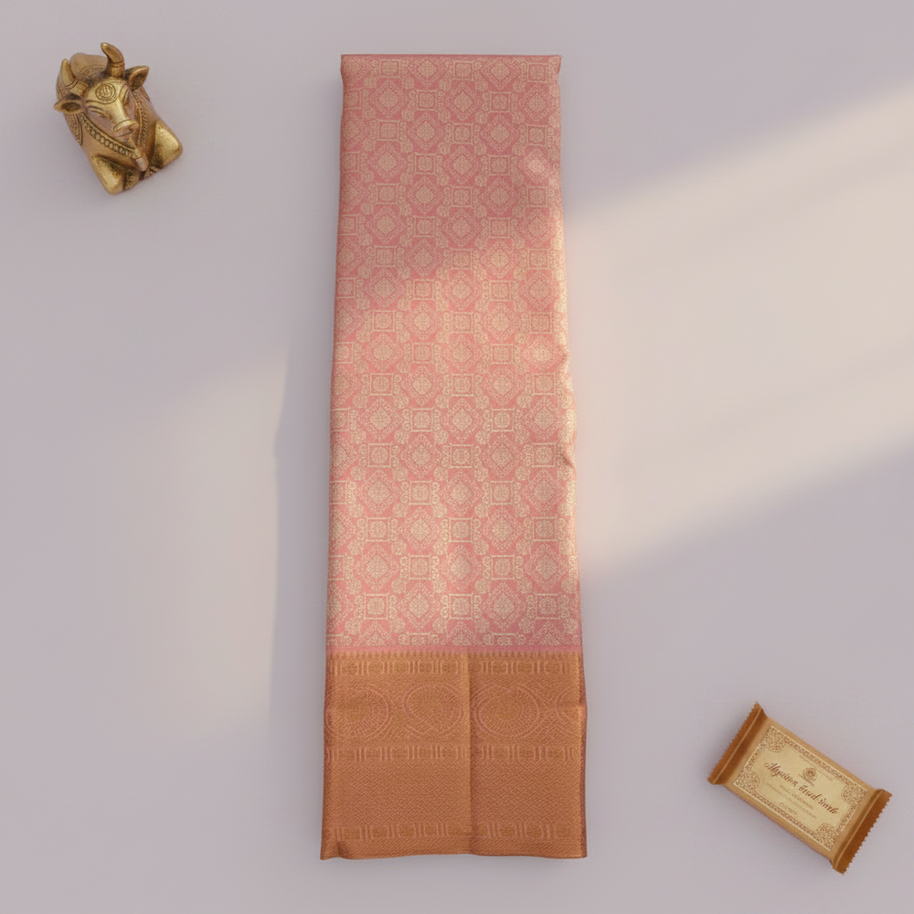 Dusty rose Kanchipuram silk saree long fold flat lay with brass Nandi figurine and Mysore sandal soap