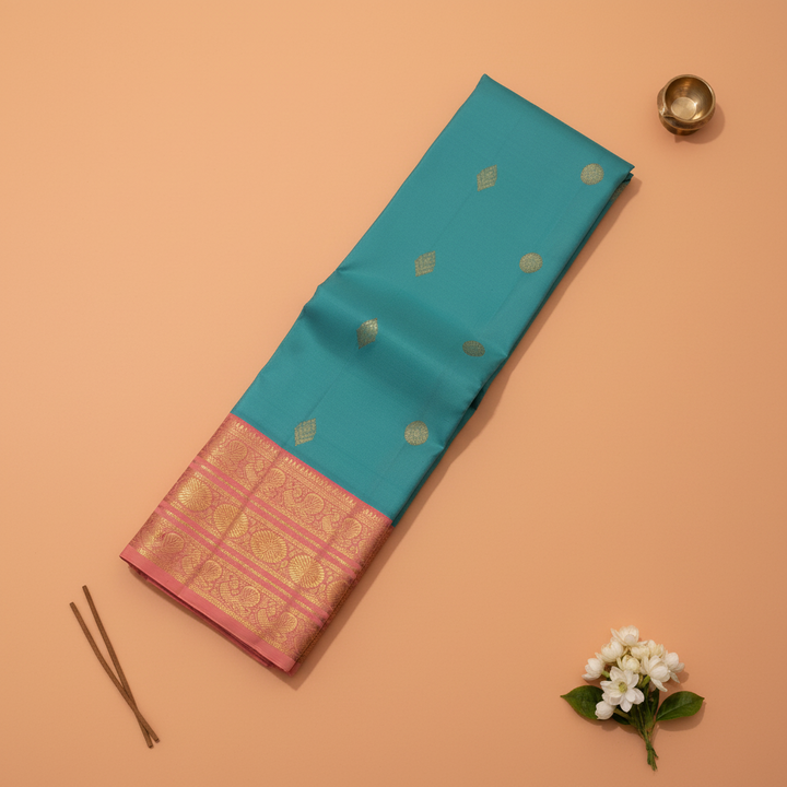 Kuberan Teal Blue Kanchipuram Silk Saree with Golden Diamond & Lotus Motifs and Rose Pink Peacock Zari Border